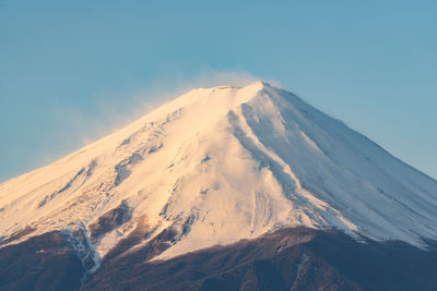 Scenic view of snowcapped mountains against clear sky