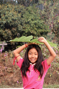 Portrait of a smiling girl standing outdoors