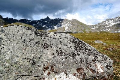 Scenic view of mountains against cloudy sky