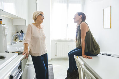 Side view of women standing in corridor