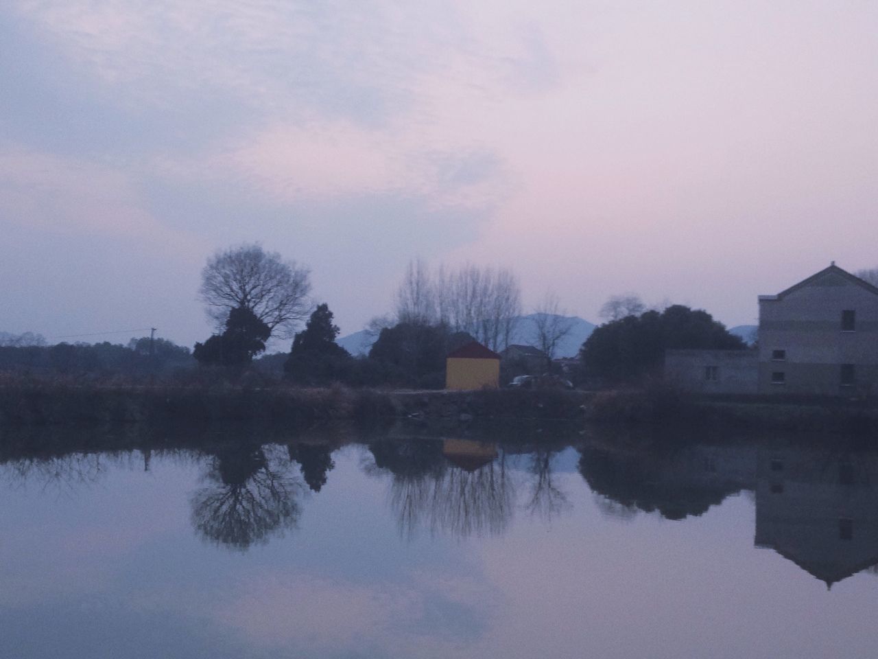 architecture, tree, built structure, building exterior, reflection, water, sky, lake, waterfront, tranquility, tranquil scene, house, nature, scenics, beauty in nature, bare tree, standing water, cloud - sky, dusk, silhouette