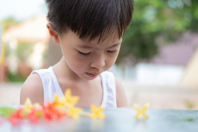 Close-up of cute boy standing outdoors