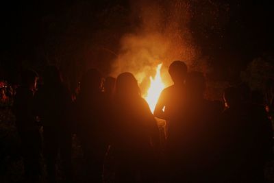 Group of people watch the bonfire