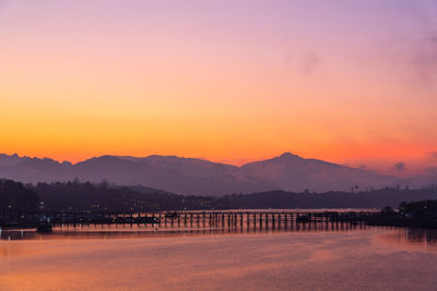 Scenic view of lake against romantic sky at sunset