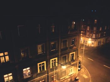 Illuminated street light in city at night