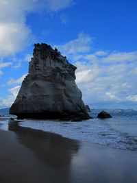 Rock formation on sea against sky