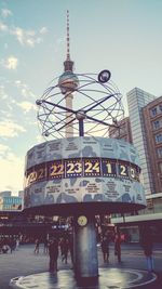 Low angle view of communications tower in city