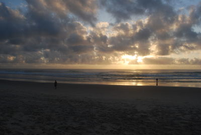 Scenic view of beach against sky during sunset