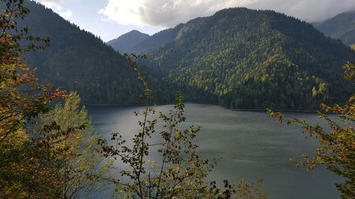 Scenic view of lake by mountains against sky