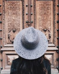 Rear view of woman in front of closed door