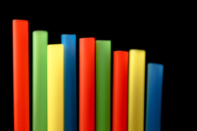 Close-up of multi colored pencils on table against black background