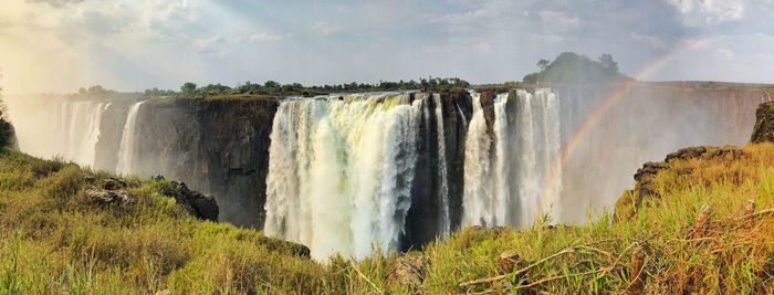 Panoramic view of waterfall against sky