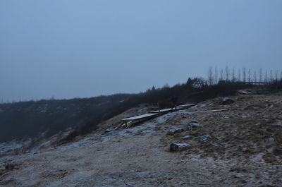 Scenic view of snowy field against clear sky