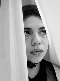 Close-up portrait of young woman looking down