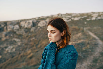 Portrait of young woman looking away