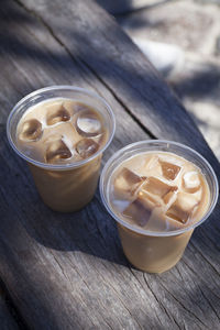 Close-up of cold coffees on wooden table