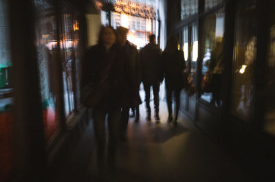 People walking in illuminated room