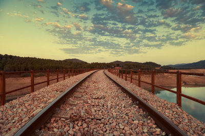 Surface level of railroad tracks against sky