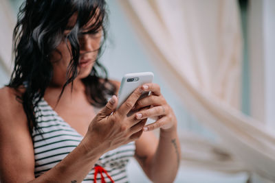 Midsection of woman using mobile phone