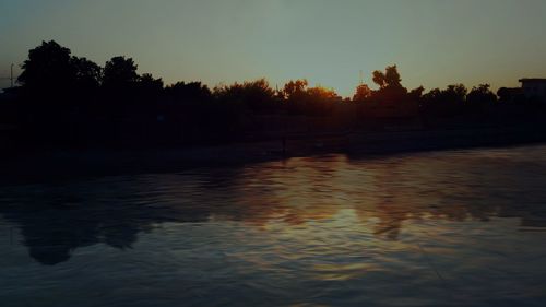 Scenic view of lake against sky at sunset