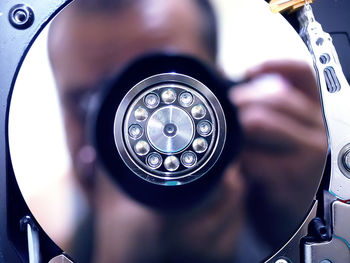 High angle portrait of man holding camera