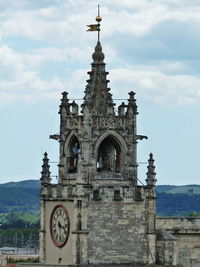 Low angle view of clock tower against sky