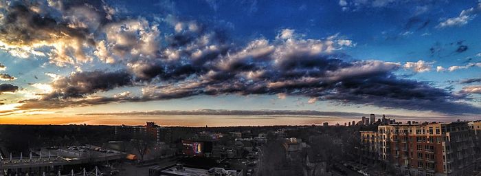 View of cityscape against cloudy sky