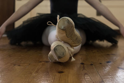 Low section of man feeding on hardwood floor