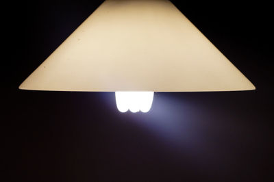 Close-up of illuminated pendant light in darkroom