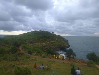 Scenic view of sea and mountains against sky