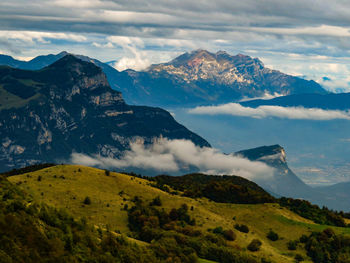 Scenic view of mountains against cloudy sky