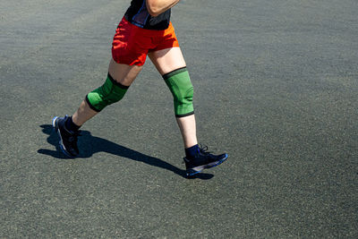 Legs elderly female runner in knee pads run race