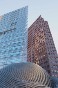 Low angle view of modern office building against sky