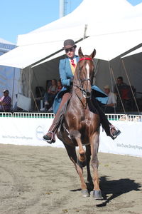 Full length of man riding horse