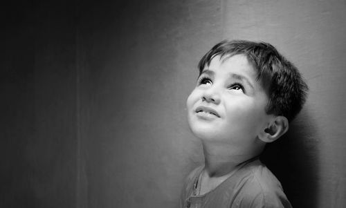 Portrait of cute boy against wall