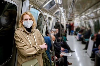 Midsection of woman standing in bus