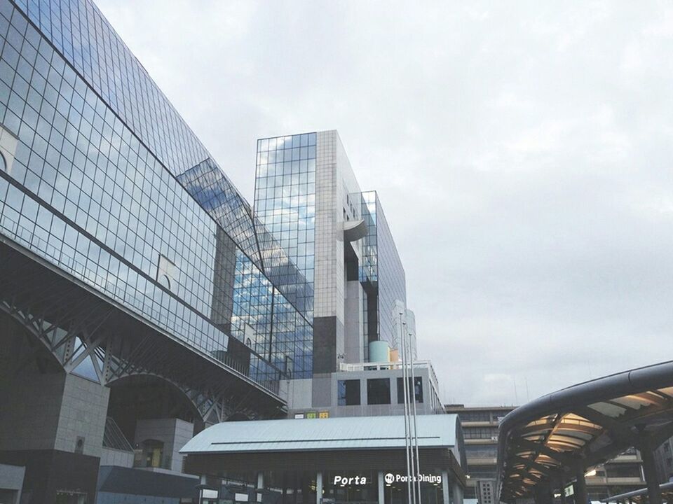 architecture, built structure, building exterior, low angle view, sky, city, modern, building, bridge - man made structure, connection, railing, cloud - sky, day, office building, no people, cloud, transportation, outdoors, city life, window