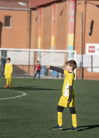 Kid football player giving directions to his team in a soccer match.