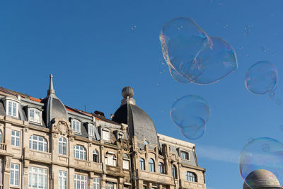 Low angle view of bubbles against clear sky