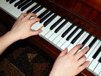 Midsection of man playing piano