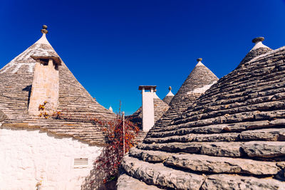 Low angle view of old building against blue sky