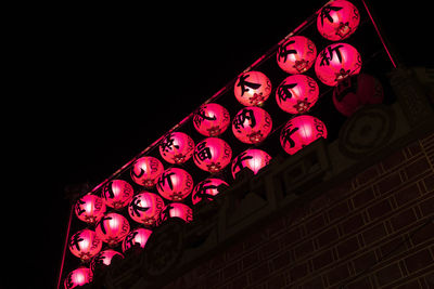 Low angle view of illuminated lights at night