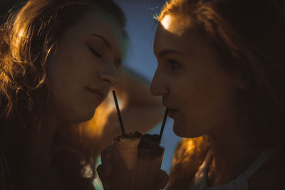 Close-up of friends drinking drink