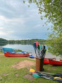 Boats moored on lake against sky