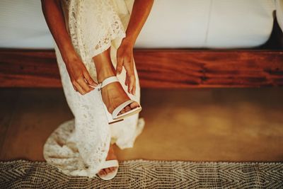 Low section of bride getting ready for wedding 