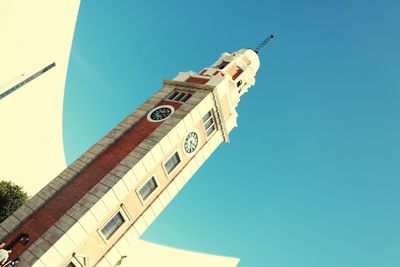 Low angle view of clock tower against clear sky