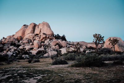 Rock formations on landscape against clear sky