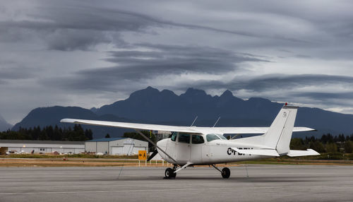 Airplane on runway against sky