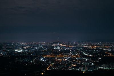 Illuminated cityscape against sky at night