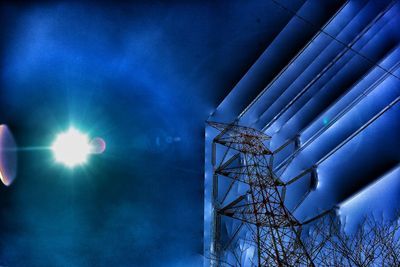 Low angle view of illuminated building against blue sky